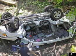 Police investigate the destroyed van that plunged over the Bronx River Parkway, Sunday April 29, 2012, in New York. (AP Photo/ Louis Lanzano)