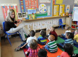 Angie Clark, a preschool teacher, reads to a group of four and five year old students, at Mitchell Elementary School, Tuesday March 29, 2011, in Des Moines, Iowa. (AP Photo/Steve Pope)