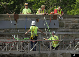 Workmen repair on old stone bridge over the Rocky River in North Olmsted, Ohio, Thursday, June 9, 2011. (AP Photo/Mark Duncan)