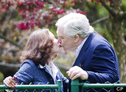 Conrad Black and his wife Barbara Amiel kiss shortly after Black arrived in his Toronto home after being released from jail.