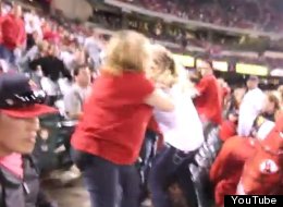 Angels fans fight in the stands during a game against the Blue Jays.