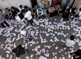 In this photo taken during a government-organized tour, Syrian campaign workers wait outside a polling station during the parliamentary elections, in Damascus, Syria, Monday, May 7, 2012. Syrians cast ballots Monday in parliamentary elections billed by the regime as key to President Bashar Assad's political reforms, but the opposition dismissed the vote as a sham meant to preserve his autocratic rule. (AP Photo/Muzaffar Salman)