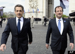 Outgoing French President Nicolas Sarkozy, left, with President-elect Francois Hollande, walk by the Arc de Triomphe in Paris, Tuesday, May 8, 2012, in Paris, during a ceremony marking the end of the anniversary of World War II in Europe. (AP Photo/Lionel Bonaventure, Pool)