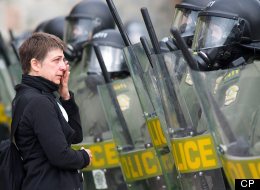 Woman crying in front of a wall of Surete du Quebec riot squad police officers as they advance to remove striking students at the College Lionel-Groulx.The Canadian Press Images-Mario Beauregard