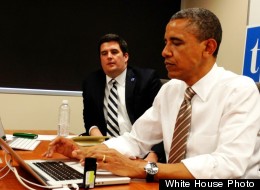 President Barack Obama answers questions on Twitter on Thursday in Newton, Iowa. Seated next to him is White House digital strategist Macon Phillips.