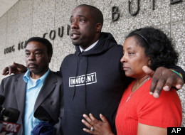 Brian Banks, center, reacts with his mother, Leomia Myers and father, Jonathan Banks, outside court after his rape conviction was dismissed Thursday May 24, 2012 in Long Beach, Calif. (Associated Press)