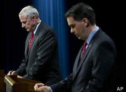 Wisconsin Gov. Scott Walker, right, and Democratic challenger Tom Barrett prepare to participate in a televised debate on May 25, 2012, in Milwaukee.