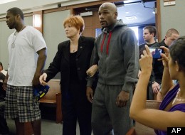 Floyd Mayweather Jr., right, walks into court escorted by his attorney Karen Winckler, center, and 50 Cent, left, to begin his 90-day jail term, Friday, June 1, 2012, in Las Vegas.
