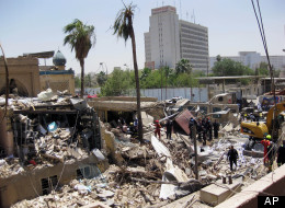Firefighters and rescuers search for victims at the site of a bomb attack in the central Bab al-Muadham area in Baghdad, Iraq, Monday, June 4, 2012. A suicide bomber detonated explosives in a car outside Iraq's main religious affairs office for Shiite Muslims tearing down part of the three-story building and killed and wounded scores of people, police said. (AP Photo/Hadi Mizban)