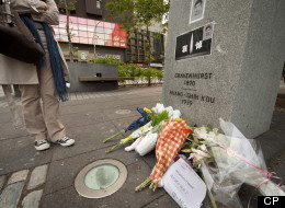 Concordia student Stephanie Chen stops for a moment where people have made a makeshift memorial for murder victim Jun Lin at the base of a monument to Norman Bethune in downtown Montreal on Monday, June 4, 2012. THE CANADIAN PRESS/Peter McCabe