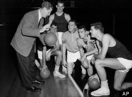 North Carolina University basketball coach Frank McGuire, left, gives his five starting players some pointers during a workout at Kansas City, Mo., Municipal Auditorium, on March 21, 1957. From left are : McGuire, Lennie Rosenbluth, Tom Kearns, Bob Cunningham, Pete Brennan, and Joe Quigg.