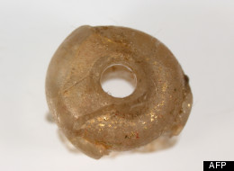 This handout picture taken on September 10, 2011, and received by AFP on June 22, 2012, shows a 5mm diameter piece of glass jewellery (top view), believed to have been made by Roman craftsmen, and found in an ancient tomb at Nagaokakyo near Kyoto, in western Japan. (AFP PHOTO / NARA NATIONAL RESEARCH INSTITUTE FOR CULTURAL PROPERTIES)