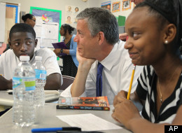 In this Monday, June 25, 2012 file photo, during a fact-finding tour of Vashon High School, U.S. Secretary of Education Arne Duncan, center, listens to eighth-grade students Delvion Mitchell, 14, and Makayla Lewis, 14, as they discuss social issues they have encountered at school and what they have learned from them, in St. Louis.