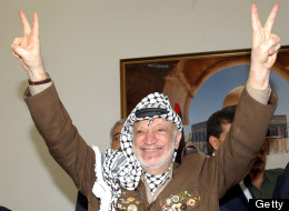 In this handout photo from the PPO, Palestinian leader Yasser Arafat makes the victory salute during a meeting in his headquarters July 10 , 2004 in Ramallah, West Bank. (Photo by Omar Rashidi/PPO via Getty Images)