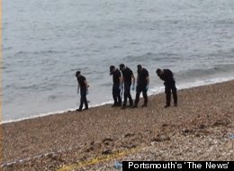 Police investigate the scene where a headless torso, wrapped in a trash bag, was found on July 3.