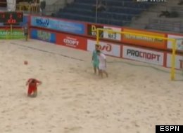 England's Matthew Evans kicks a ball in frustration that hits a Belarus player in the head during a beach soccer match.