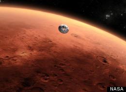 This illustration depicts the moment immediately after the Curiosity rover touches down on the Red Planet.