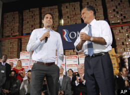 Mitt Romney watches as his son Craig speaks Spanish to a crowd during a campaign stop, Tuesday, Nov. 29, 2011, in Medley, Fla.