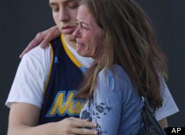 Jacob Stevens, 18, hugs his mother Tammi Stevens after being interview by police outside Gateway High School where witness were brought for questioning after a shooting at a movie theater, Friday, July 20, 2012 in Denver. A gunman wearing a gas mask set off an unknown gas and fired into a crowded movie theater at a midnight opening of the Batman movie