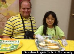 Zach Grossman and his daughter volunteering at I-HELP on July 19, 2012. Photo courtesy of Guardian Angels Catholic Community