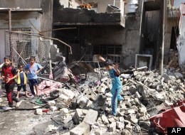 Children gather at the scene of a bomb attack in Madain, about 15 miles (25 kilometers) southeast of Baghdad, Iraq, Monday, July 23, 2012. An onslaught of bombings and shootings killed scores of people across Iraq on Monday, in the nation’s deadliest day so far this year. The attacks come days after the leader of al-Qaida in Iraq declared a new offensive seeking to re-assert its might in the security vacuum left by the departing Americans. (AP Photo/Karim Kadim)