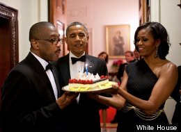 President Barack Obama and First Lady Michelle Obama present a birthday cake to Assistant Usher Reggie Dickson June 13. (Official White House Photo by Pete Souza)
