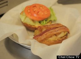 An 8 a.m. burger with a fried egg and applewood-smoked bacon mid-assembly.
