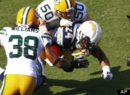 San Diego Chargers running back Ryan Mathews (24) is tackled by Green Bay Packers linebacker A.J. Hawk (50) as he carries the ball on his first run in an NFL preseason football game, Thursday, Aug. 9, 2012, in San Diego. Mathews broke his clavicle on the 5-yard run. (AP Photo/Matt York)