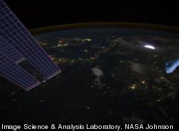 A sprite glows red (inset) in this image captured by astronauts on the International Space Station on April 30, 2012.