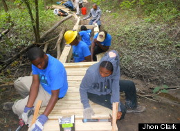 File Photo. A crew of Detroit teens construct a 24 foot wooden bridge over a Rouge River drainage canal. (Jhon Clark)