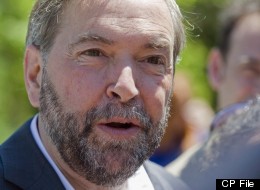 NDP leader Thomas Mulcair speaks to reporters during the official opening of Jack Layton park in the town of Hudson, Que., on June 23, 2012. The New Democratic Party of Canada has paid back a total of $344,468 it obtained in sponsorship revenue since 2006 after Elections Canada found the federal party guilty of violating political financing laws following a complaint filed by the Conservative Party of Canada. THE CANADIAN PRESS/Graham Hughes