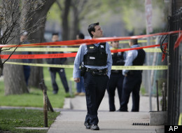 Police officers work a crime scene where they discovered the bodies of three shooting victims at a home on Chicago's Southwest side Wednesday, April 30, 2008 in Chicago. (AP Photo/M. Spencer Green)