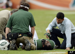 New York Jets trainers attend to cornerback Darrelle Revis during the second half of an NFL football game against the Miami Dolphins, Sunday, Sept. 23, 2012, in Miami.