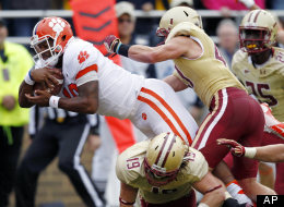 Clemson quarterback Tajh Boyd, top left, goes over Boston College defensive back Sean Sylvia to score in the first quarter of an NCAA college football game in Boston, Saturday, Sept. 29, 2012.