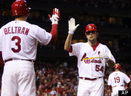St. Louis Cardinals' Jaime Garcia is congratulated by Carlos Beltran as he returns to the dugout after hitting a solo home run against the Cincinnati Reds in the third inning of a baseball game, Monday, Oct. 1, 2012, in St. Louis.