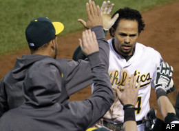 Oakland Athletics' Coco Crisp celebrates in the dugout after scoring on a double by Stephen Drew in the sixth inning of Game 4 of their American League division baseball series against the Detroit Tigers in Oakland, Calif., Wednesday, Oct. 10, 2012.