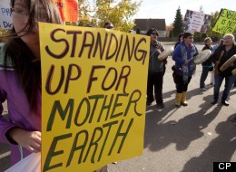 Demonstrators stand outside the Joint Review Panel looking into the Northern Gateway Pipeline in Prince George, B.C. Tuesday, Oct. 9, 2012. THE CANADIAN PRESS/Jonathan Hayward