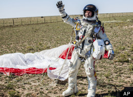 In this photo provided by Red Bull Stratos, Pilot Felix Baumgartner of Austria celebrates after successfully completing the final manned flight for Red Bull Stratos in Roswell, N.M., Sunday, Oct. 14, 2012. Baumgartner came down safely in the eastern New Mexico desert minutes about nine minutes after jumping from his capsule 128,097 feet, or roughly 24 miles, above Earth. (AP Photo/Red Bull Stratos, Balazs Gardi)