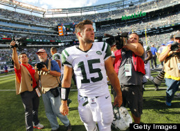 Tim Tebow of the New York Jets walks off the field after the Jets defeated the Buffalo Bills 48-28 during an NFL game at MetLife Stadium on September 9, 2012 in East Rutherford, New Jersey.