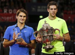 Argentina's Juan Martin Del Potro (R) poses with the trophy next to Switzerland's Roger Federer after winning his final match at the Swiss Indoors ATP tennis tournament on October 28, 2012 in Basel.