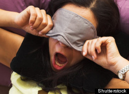 Woman trying to sleep on a flight.