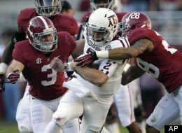 Texas A&M quarterback Johnny Manziel (2) is stopped after a first down run by Alabama defensive back Dee Milliner (28) and defensive back Vinnie Sunseri during the first half of an NCAA college football game at Bryant-Denny Stadium in Tuscaloosa, Ala., Saturday, Nov. 10, 2012.