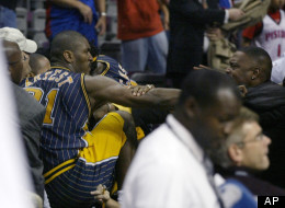 This Nov. 19, 2004 file photo shows Indiana Pacers forward Ron Artest fighting with a fan during a a brawl at a game against the Detroit Pistons, in Auburn Hills, Mich.