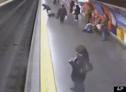 Closed-circuit television cameras captured dramatic images of a Spanish police officer saving a woman from the subway tracks in the Madrid underground as a train was about the enter the station