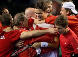 Canada's Milos Raonic is mobbed by teammates after defeating Spain's Guillermo Garcia-Lopez during a Davis Cup tennis world group first-round tie singles match in Vancouver on Sunday. (AP Photo/The Canadian Press/Darryl Dyck)