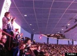 Vancouver Whitecaps fans, known as Southsiders, stand and clap at a Canucks game. At least two were ejected by Canucks security. (Twitter: Duncan Nicol)
