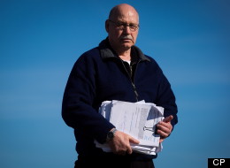 Cran Campbell holds printed pages of online hate postings while posing for a photograph in Delta, B.C., on Feb. 15. (THE CANADIAN PRESS/Darryl Dyck)